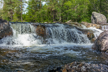 A waterfall in a wild forest in a national park in Norway - 3