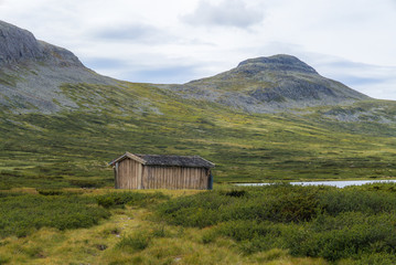 Fototapeta na wymiar Isolated fishing hut on a lake in Norway - 4