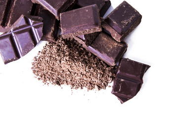 grated chocolate and chunks of chocolate isolated on white