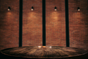 Empty wooden table and blur background of abstract in front of wall texture or old brick wall can be used Mock up for display of product or for montage