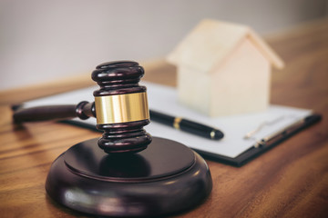 Gavel on sounding block at courtroom for decide home insurance, Law and justice concept, Settle a...