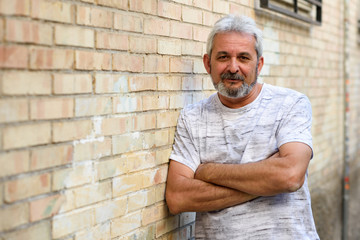 Mature man smiling looking at camera in urban background