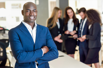 Businessman leader in modern office with businesspeople working at background