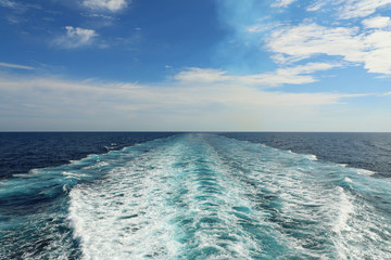 Obraz na płótnie Canvas Ship wake or trail on ocaen surface, white trace on water surface.