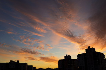 Beautiful clouds at sunrise, over the city roofs - Powered by Adobe
