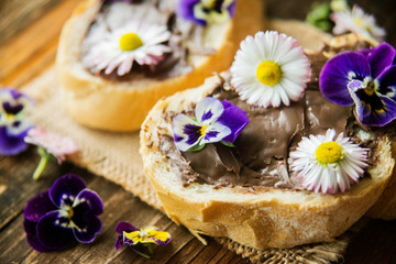 Sweet berry bruschetta with chocolate nut butter,mint and sliced almonds on the white vintage dish