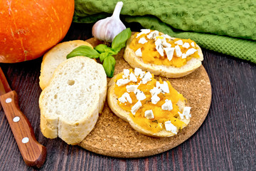 Bruschetta with pumpkin and basil on board