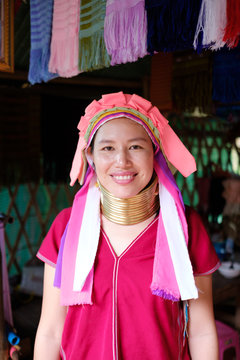 Long Neck Karen girl with traditional brass coils and clothes in tribe village.