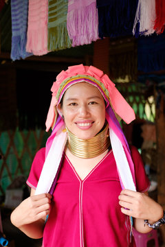 Long Neck Karen girl with traditional brass coils and clothes in tribe village.