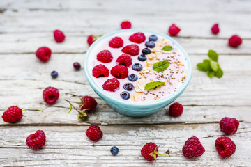 A bowl of healthy and delicious smoothie with grains and fresh berry fruit. 