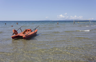 FOLLONICA, ITALY - AUGUST 21 2015: Summer season in Follonica, Tuscany, with lifeboat on the sea and few person