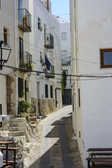 Fototapeta premium Cobbled and narrow street in the tourist town of Peñiscola.