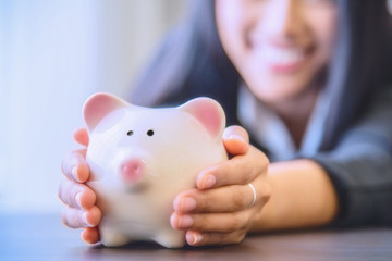 Piggy bank in hand.