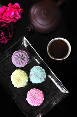 Fototapeta na wymiar Above Shot of Mooncake and Tea on Black Background