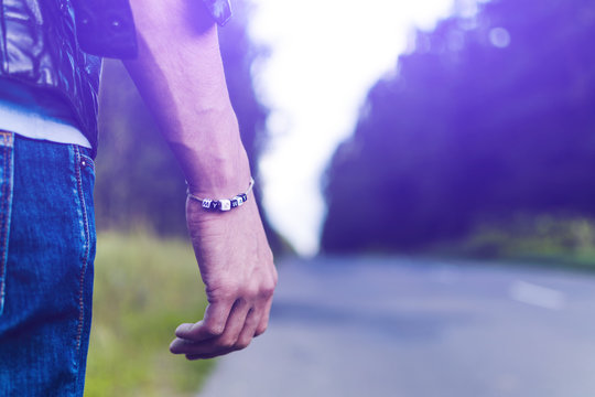 A young man walks along an empty road in search of his path. Evening, autumn, search.