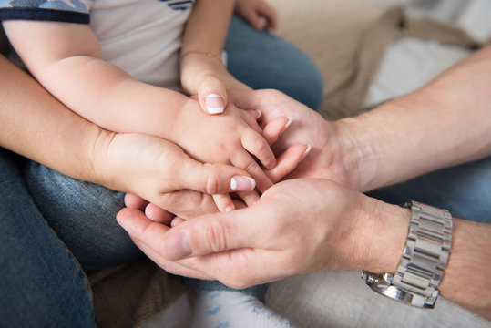 Parents and child holding hands together
