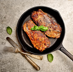 grilled steak and basil on a frying pan