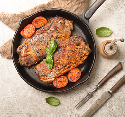 grilled steak and basil on a frying pan