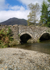 Fototapeta na wymiar A medieval stone bridge in the british countryside. English historical history Heritage.
