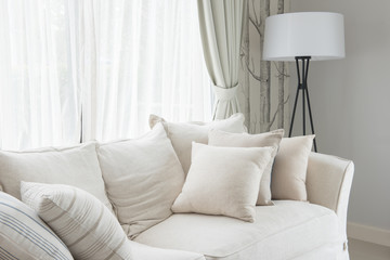 set of pillows on white classic sofa in living room