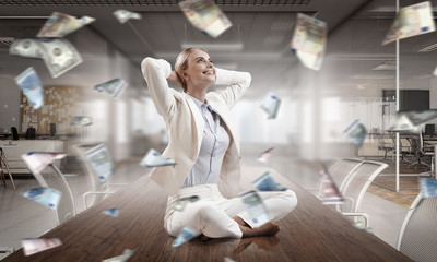 Business lady meditating at work. Mixed media