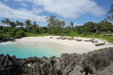 Boats anchor on the Mandorak Beach shoreline at Southwest Sumba, Indonesia
