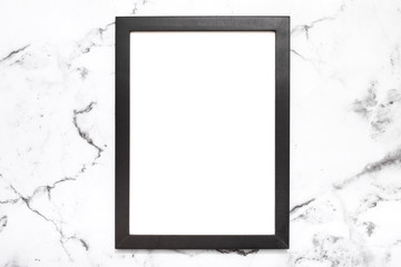 Blank black color picture frame on white marble table top view, Mock up for adding your photo in copy space