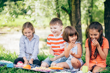 Group of happy smiling friends playing outdoors in spring park