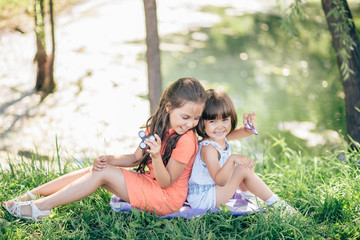 Children on grass smiling and playing in spinner