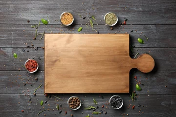 Wandcirkels Kruiden Composition with cutting board, spices and herbs on wooden background  © Africa Studio