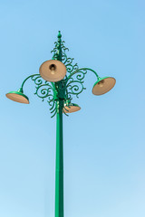 The old lamp on the beautiful antique green pillar.