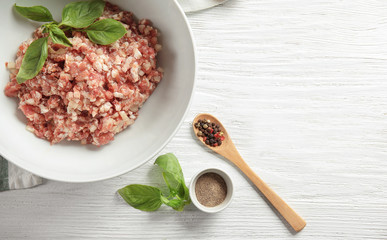 Bowl with ground turkey for delicious meatloaf on table