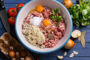 Bowl with ingredients for delicious turkey meatloaf on wooden table