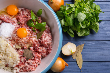 Bowl with ingredients for delicious turkey meatloaf on wooden table