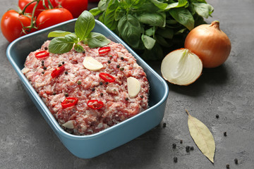 Baking dish with raw turkey meatloaf on table