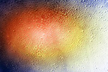 glass coated with water droplets. Misted window. Sunset light. Autumn rain