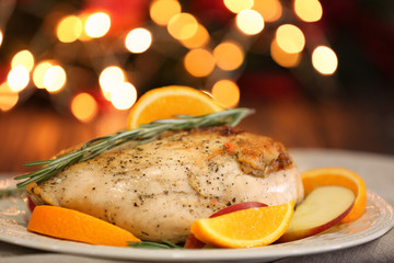 Plate with delicious turkey breast against blurred lights