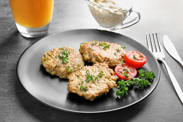 Delicious broccoli pancakes with cherry tomato and fresh parsley on dark background
