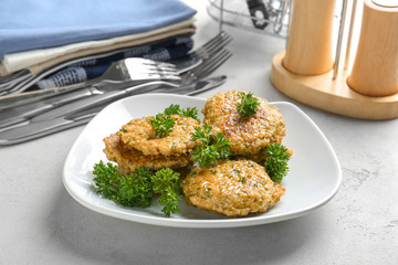 Delicious broccoli pancakes with fresh parsley on kitchen table