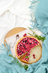 Flat lay breakfast in bed with raspberry cheesecake, mint tea