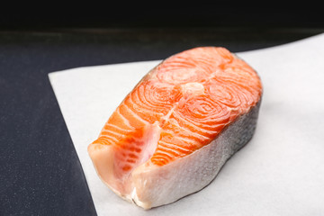 Salmon steak on white paper, closeup