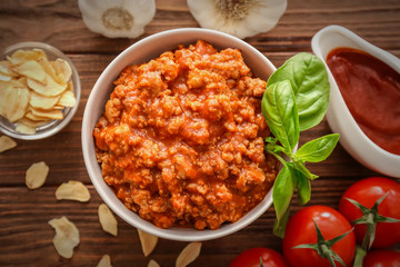 Meat sauce in ceramic bowl on kitchen table