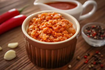 Meat sauce in ceramic bowl on kitchen table