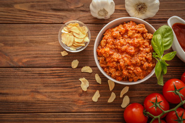 Meat sauce in ceramic bowl on kitchen table