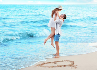 Happy young couple on sea beach