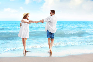 Happy young couple on sea beach