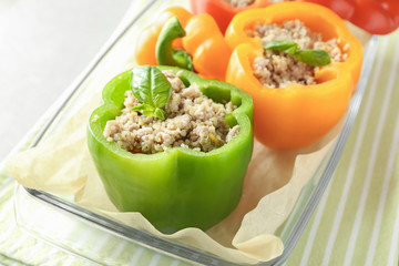 Quinoa stuffed peppers in glass baking dish, closeup
