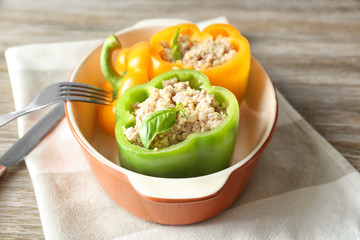 Quinoa stuffed peppers in casserole dish on dinner table