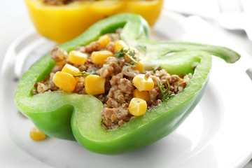 Quinoa stuffed peppers on white plate, closeup