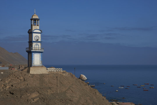 Historic wooden clock tower from the era of nitrate mining in the Atacama Desert, in the coastal town of Pisagua in the Tarapaca Region of northern Chile.